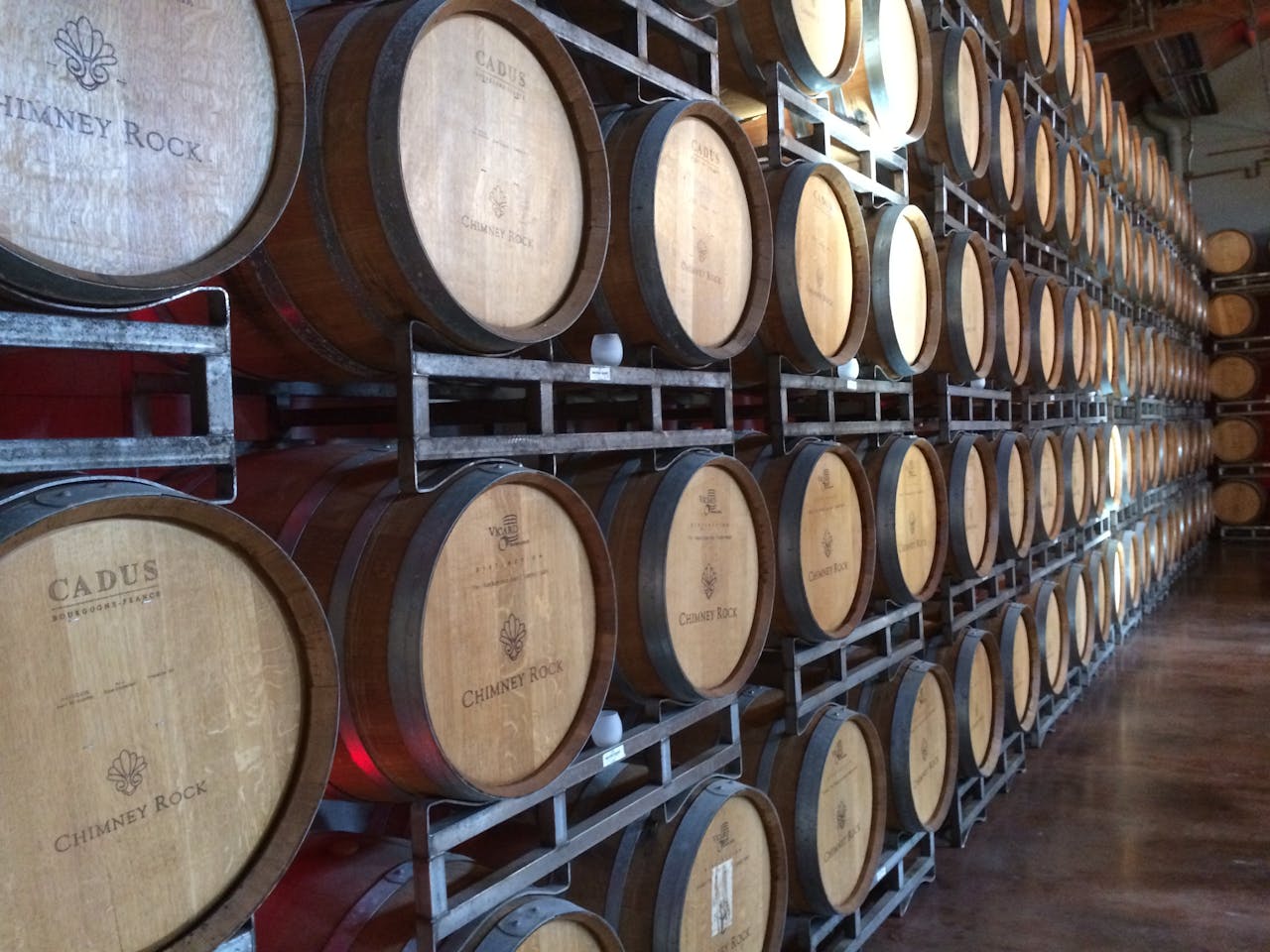 heros-img Wooden wine barrels in a Napa, CA winery, ideal for wine production visuals.
